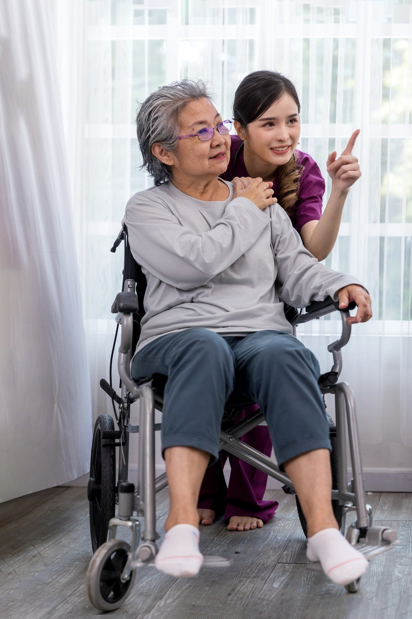 caregiver-nurse-take-care-a-senior-patient-sit-on-wheelchair-nurse-helping-senior-woman.jpg